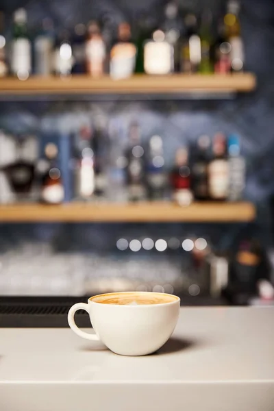 Selective focus of hot and tasty cappuccino in white cup — Stock Photo