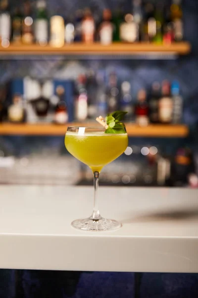 Mixed alcohol cocktail in glass on bar counter — Stock Photo