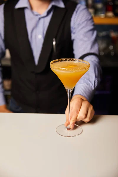 Vista recortada de barman sosteniendo vaso de margarita con cóctel frío y fresco - foto de stock