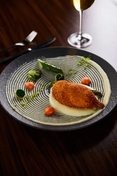 Delicious chicken kiev and mashed potato served on plate on wooden table — Stock Photo