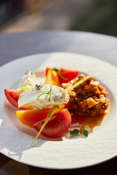 Delicious eggplant caviar with tomato and butter served in restaurant in sunlight — Stock Photo