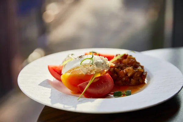 Delicious eggplant caviar with tomato and butter served in restaurant in sunlight — Stock Photo