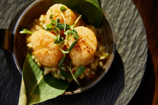 Top view of delicious grilled scallops served in pan with microgreens in sunlight — Stock Photo