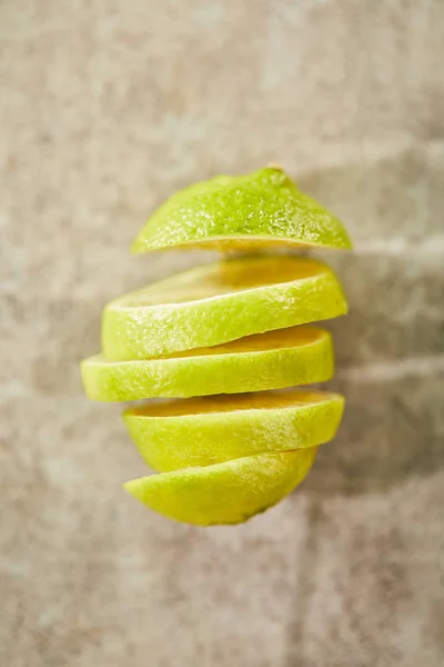 Top view of sliced and ripe lime on marble surface — Stock Photo