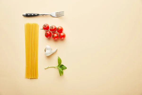 Flat lay with delicious spaghetti with tomato sauce ingredients on yellow background — Stock Photo