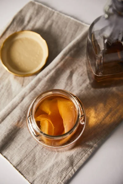 Top view of jar with kombucha on grey napkin — Stock Photo