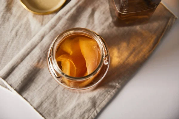 Top view of jar with kombucha on grey napkin — Stock Photo