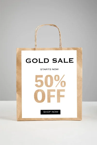 Paper shopping bag with gold sale 50 percent off illustration isolated on grey, black Friday concept — Stock Photo