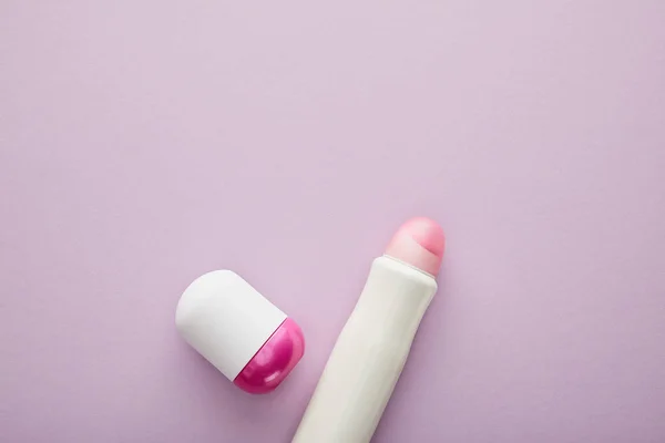 Top view of bottles of deodorant on violet background — Stock Photo