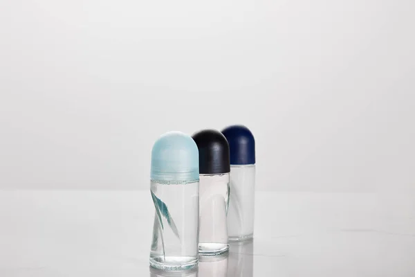 Selective focus of transparent bottles of roller deodorant isolated on white — Stock Photo