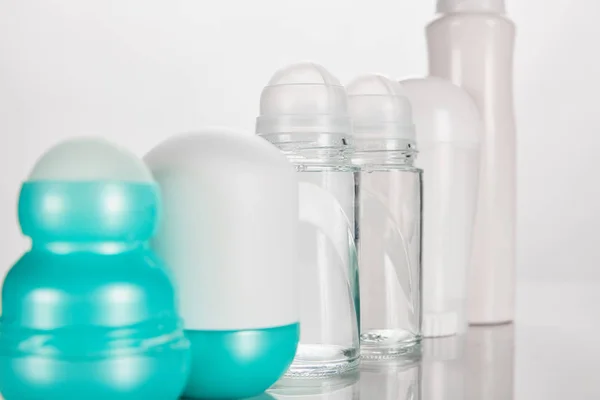 Selective focus of bottles of deodorant isolated on white — Stock Photo