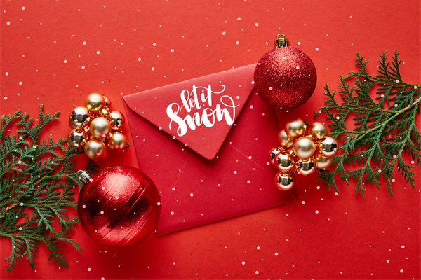 Top view of shiny Christmas decoration, envelope with let it snow illustration and thuja — Stock Photo