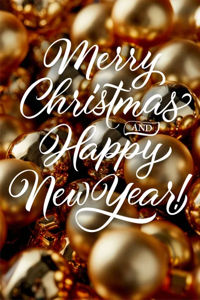 Close up view of shiny golden Christmas baubles with merry Christmas and happy New year illustration — Stock Photo