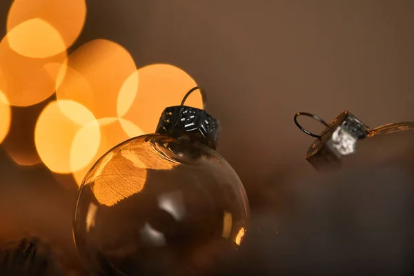 Close up of transparent christmas balls with blurred yellow lights — Stock Photo
