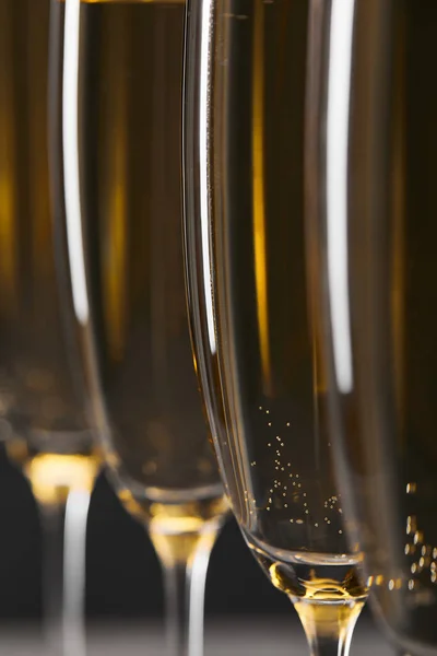 Gros plan de vin mousseux dans des verres pour célébrer la veille de Noël sur gris — Photo de stock