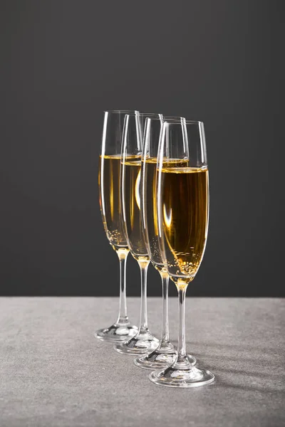 Sparkling wine in glasses for celebrating christmas eve on grey — Stock Photo