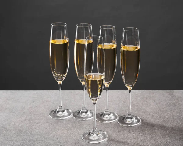 Champagne in glasses for celebrating christmas eve on grey — Stock Photo