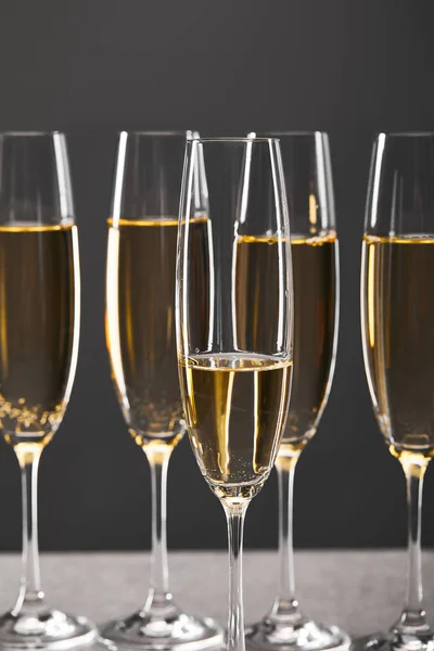 Glasses of champagne for celebrating christmas eve on grey — Stock Photo