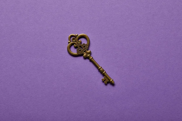 Top view of vintage key on violet background — Stock Photo