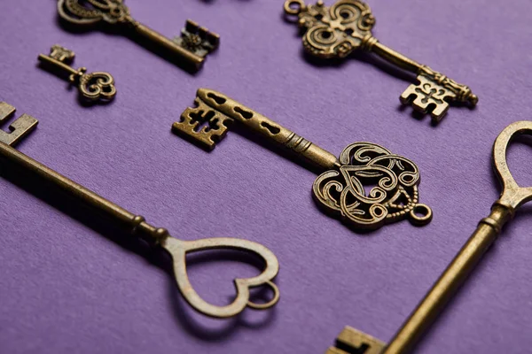 Close up view of vintage keys on violet background — Stock Photo