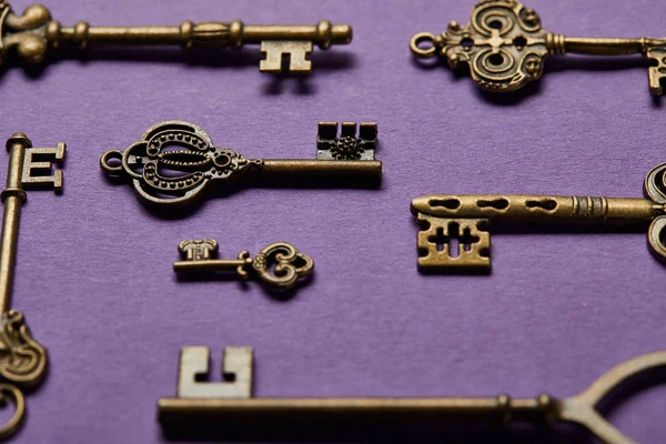 Close up view of vintage keys on violet background — Stock Photo