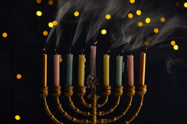 Candles in menorah on black background with bokeh lights on Hanukkah — Stock Photo