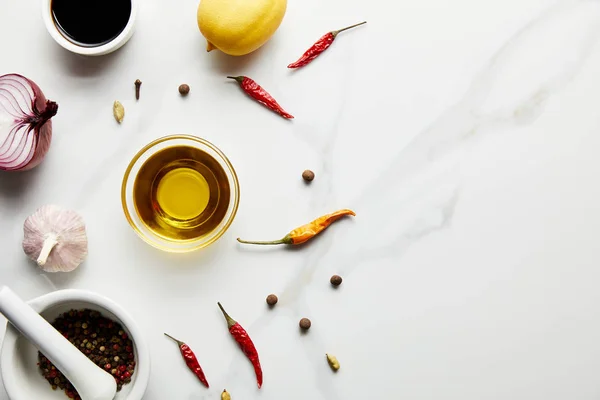 Vista dall'alto di limone, olio d'oliva con salsa di soia e spezie su fondo di marmo — Foto stock