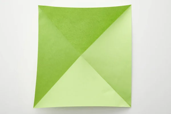 Top view of empty green origami paper on white background — Stock Photo