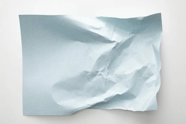 Top view of empty crumpled blue paper on white background — Stock Photo