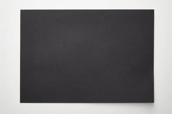 Top view of empty black paper on white background — Stock Photo