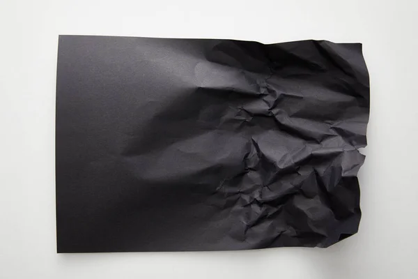 Top view of empty crumpled black paper on white background — Stock Photo