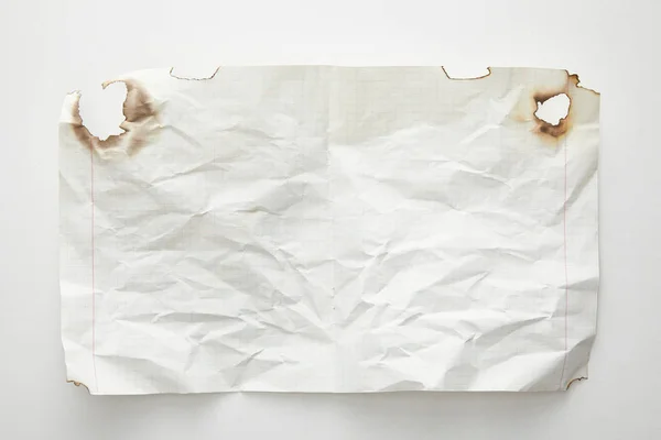 Top view of empty crumpled and burnt vintage paper on white background — Stock Photo