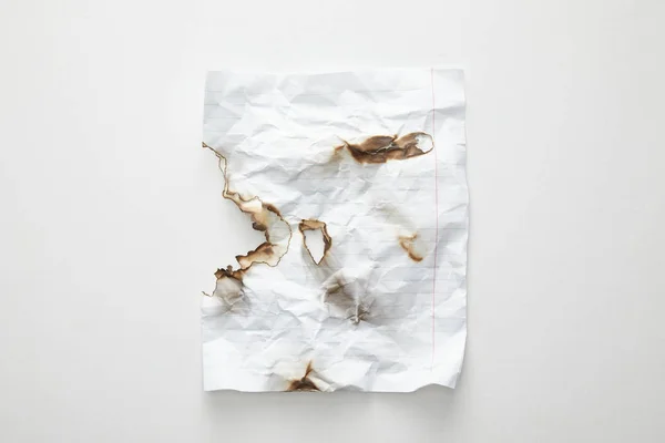 Top view of empty crumpled and burnt vintage paper on white background — Stock Photo