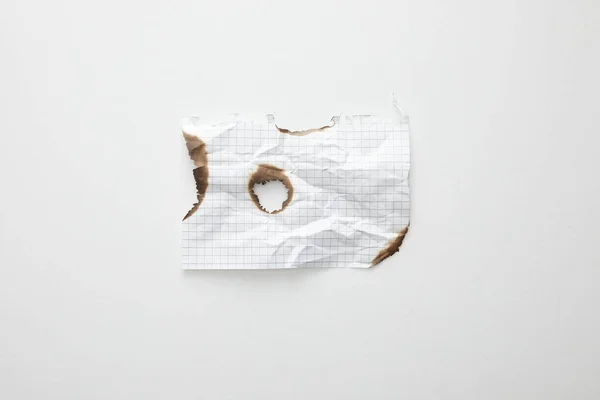 Top view of empty crumpled and burnt vintage paper on white background — Stock Photo