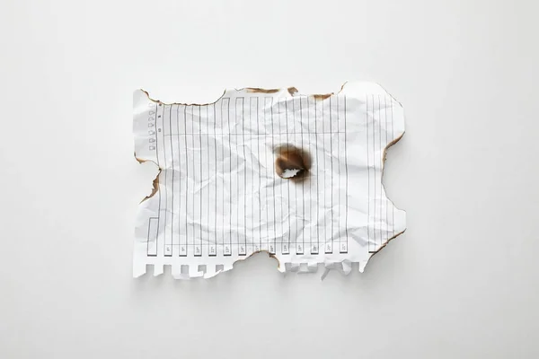 Top view of empty crumpled and burnt vintage paper on white background — Stock Photo