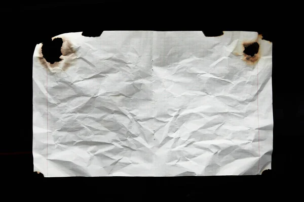 Top view of empty white crumpled and burnt vintage paper isolated on black — Stock Photo