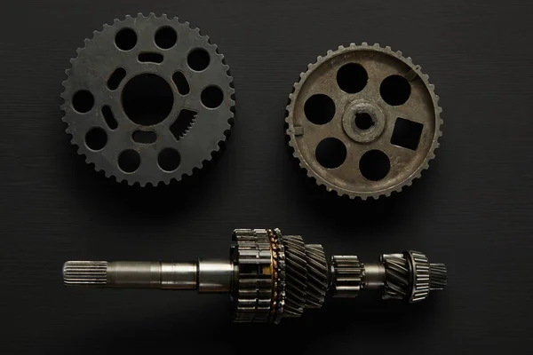 Top view of aged gears on black surface — Stock Photo