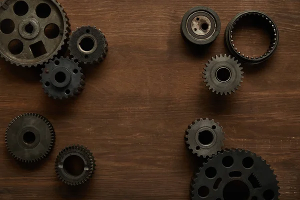 Top view of aged gears on wooden table — Stock Photo