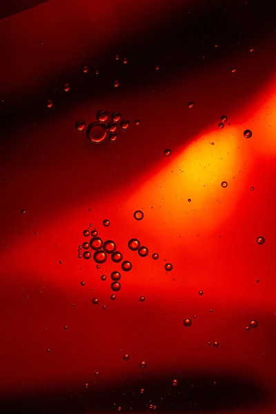 Abstract red color background from mixed water and oil bubbles — Stock Photo