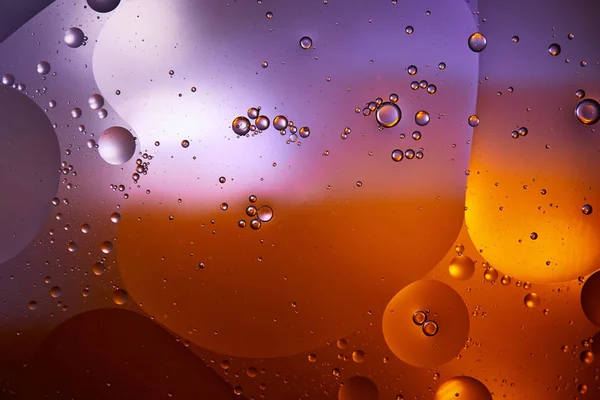 Beautiful abstract background from mixed water and oil in orange and purple color — Stock Photo