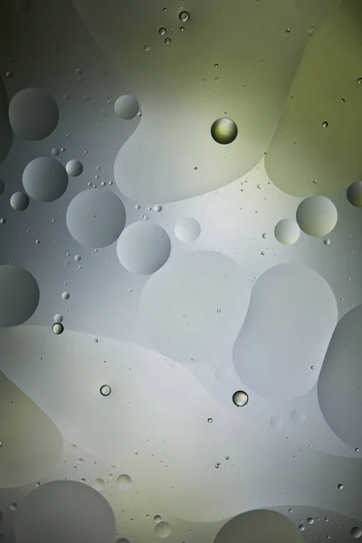 Creative abstract background from mixed water and oil in light green and grey color — Stock Photo
