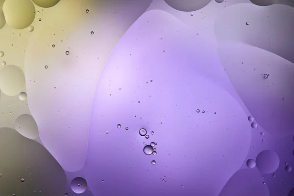 Creative purple and green color abstract background from mixed water and oil bubbles — Stock Photo