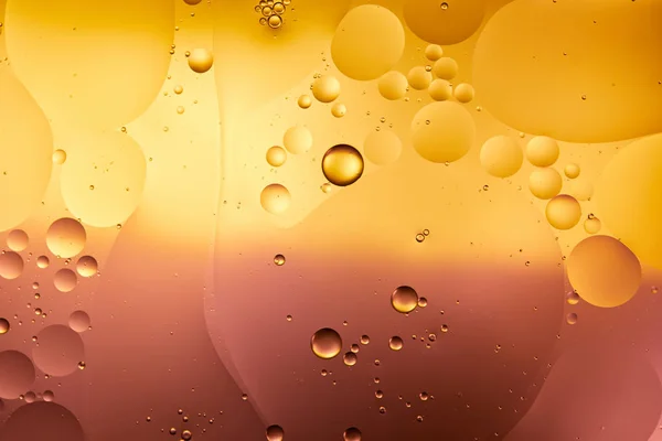 Beautiful abstract background from mixed water and oil in orange and pink color — Stock Photo