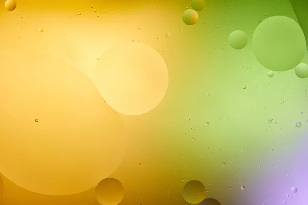 Красивий оранжевий, фіолетовий і зелений кольори абстрактний фон зі змішаної води і олії — стокове фото