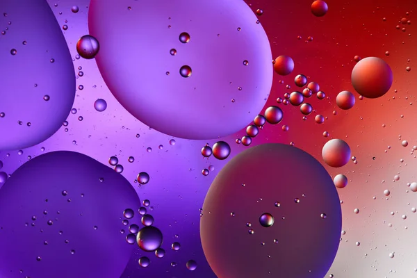 Creative abstract purple and red color background from mixed water and oil bubbles — Stock Photo