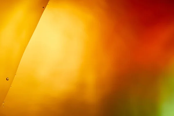 Beau fond de couleur orange, rouge et vert de l'eau et de l'huile mélangées — Photo de stock