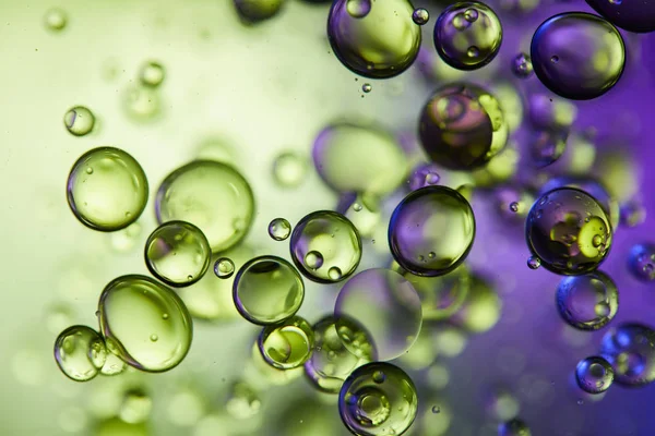 Creative purple and green color abstract background from mixed water and oil bubbles — Stock Photo