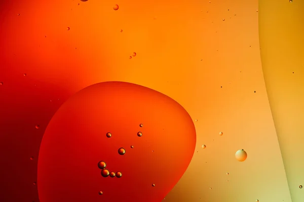 Beautiful abstract background from mixed water and oil in orange color — Stock Photo