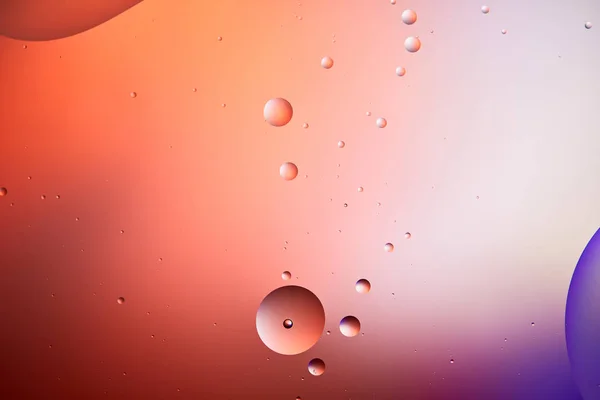 Abstract creative background from mixed water and oil bubbles in red and purple color — Stock Photo