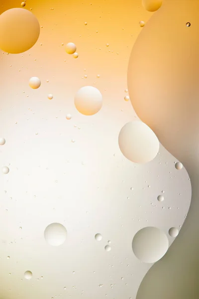 Beautiful abstract background from mixed water and oil in light orange and grey color — Stock Photo